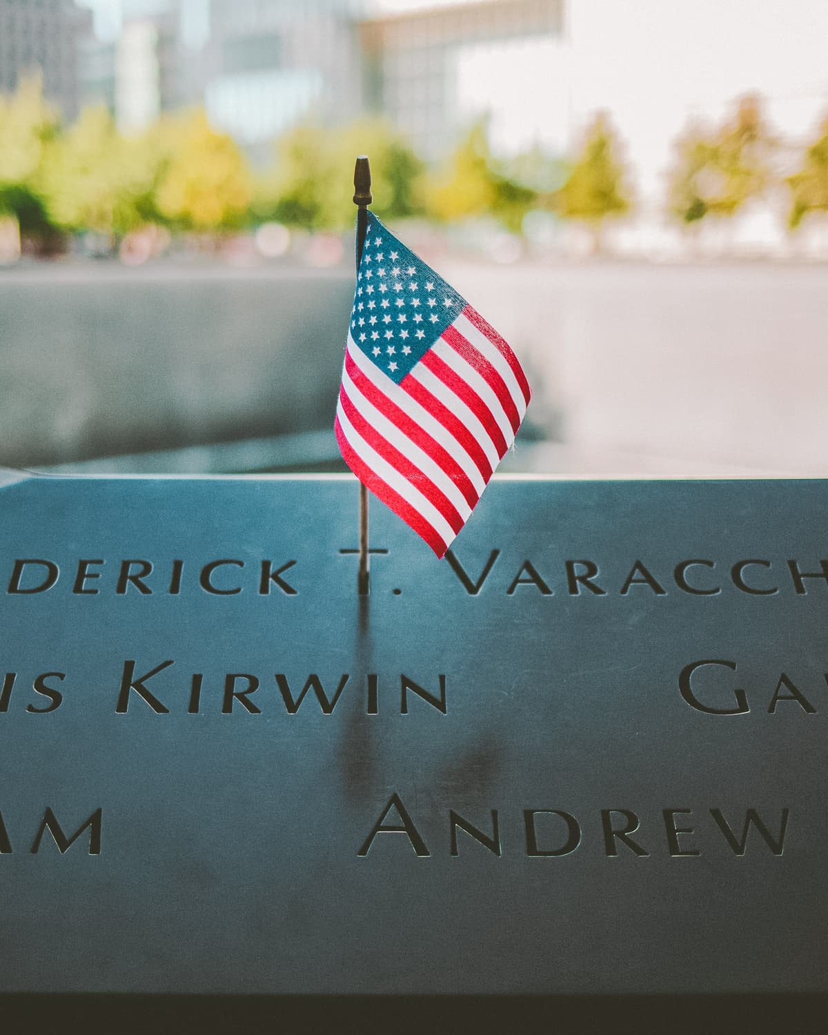 American Flag next to name at the 911 Memorial